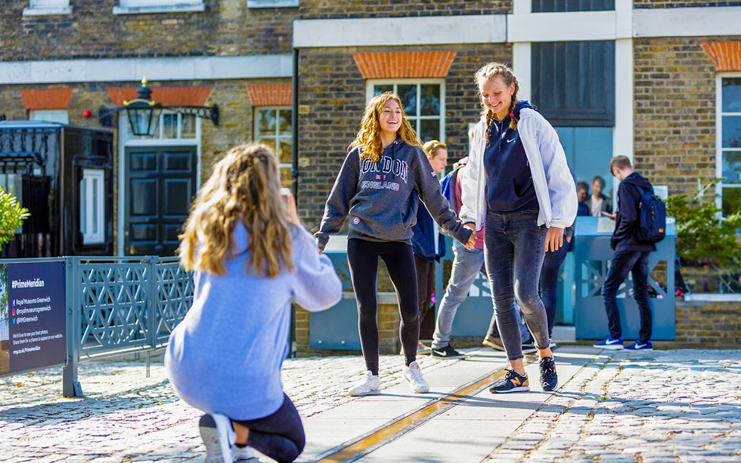 Guests standing on the Prime Meridian line at Royal Observatory Greenwich.