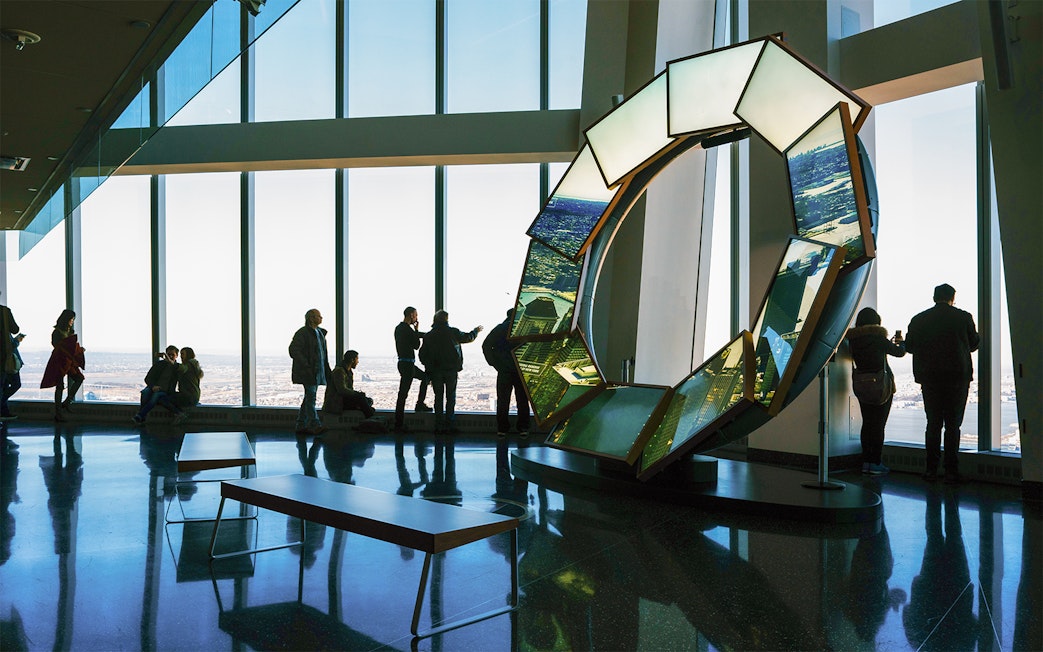 Visitors enjoying panoramic views at One World Observatory, New York City.