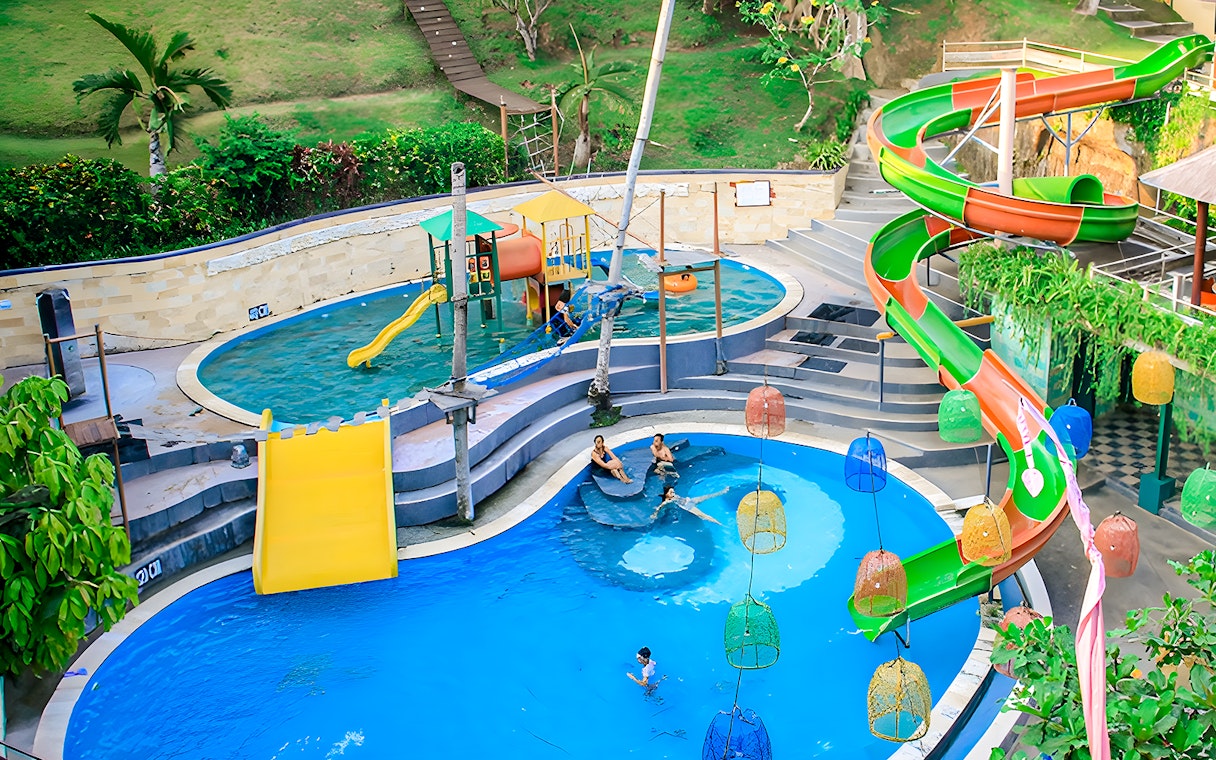 Keramas Park Bali water slides and pools with visitors enjoying the attractions.