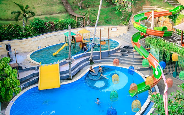 Keramas Park Bali water slides and pools with visitors enjoying the attractions.