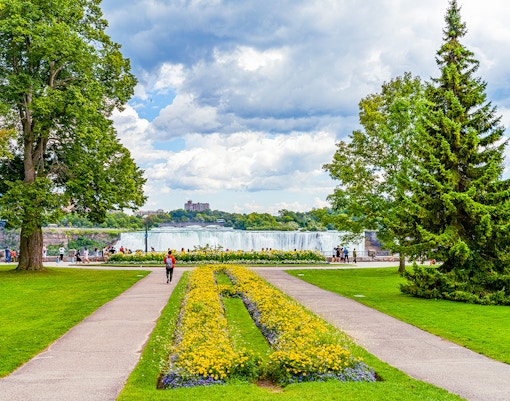Niagara Falls view from Queen Victoria Park, showcasing cascading waterfalls and lush greenery.