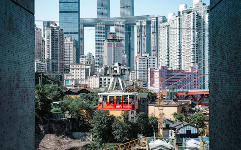 Chongqing skyline with cable car crossing over city buildings.