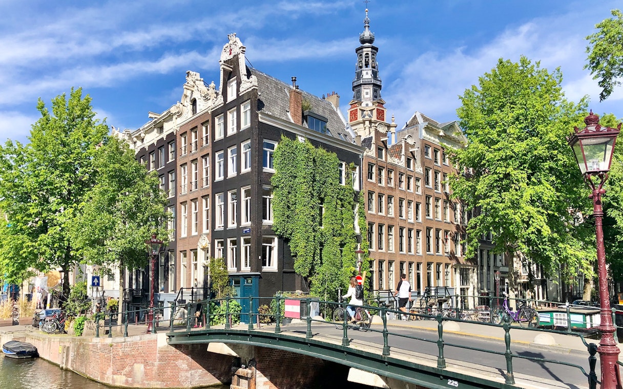 Anne Frank House exterior with canal and bridge in Amsterdam.