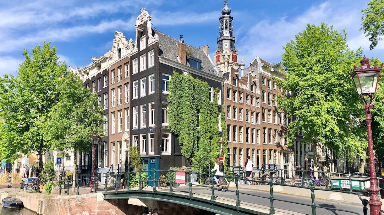 Anne Frank House exterior with canal and bridge in Amsterdam.
