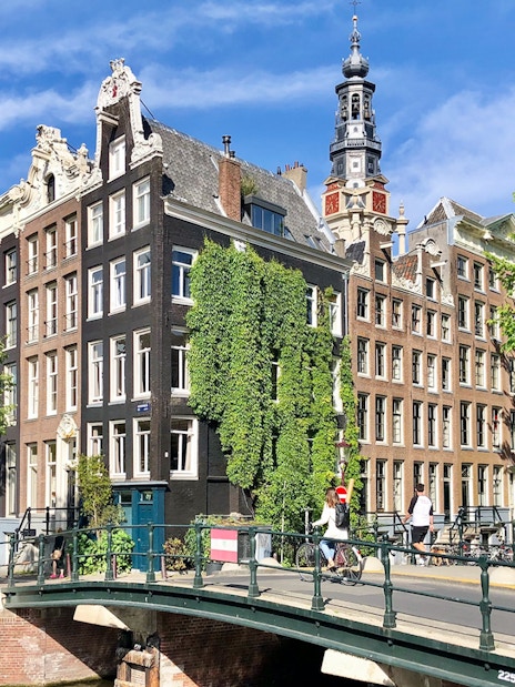 Anne Frank House exterior with canal and bridge in Amsterdam.