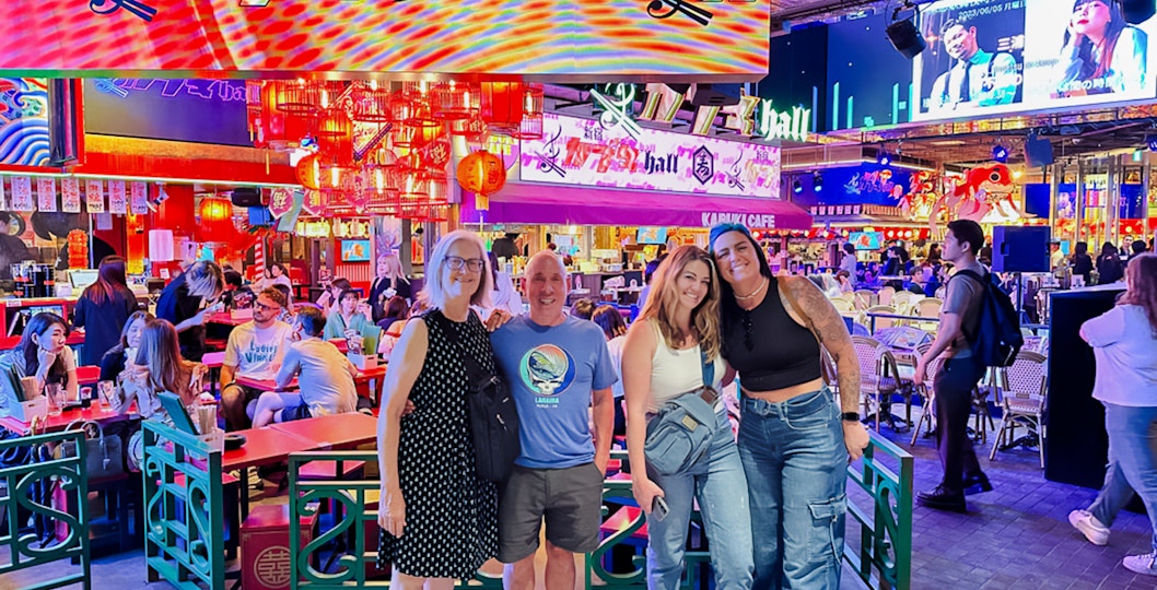 Group enjoying a vibrant restaurant during a nighttime food tour in Shinjuku, Tokyo.