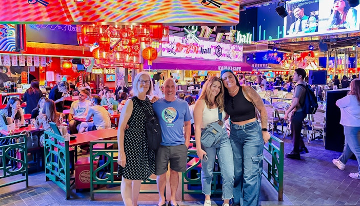 Group enjoying a vibrant restaurant during a nighttime food tour in Shinjuku, Tokyo.