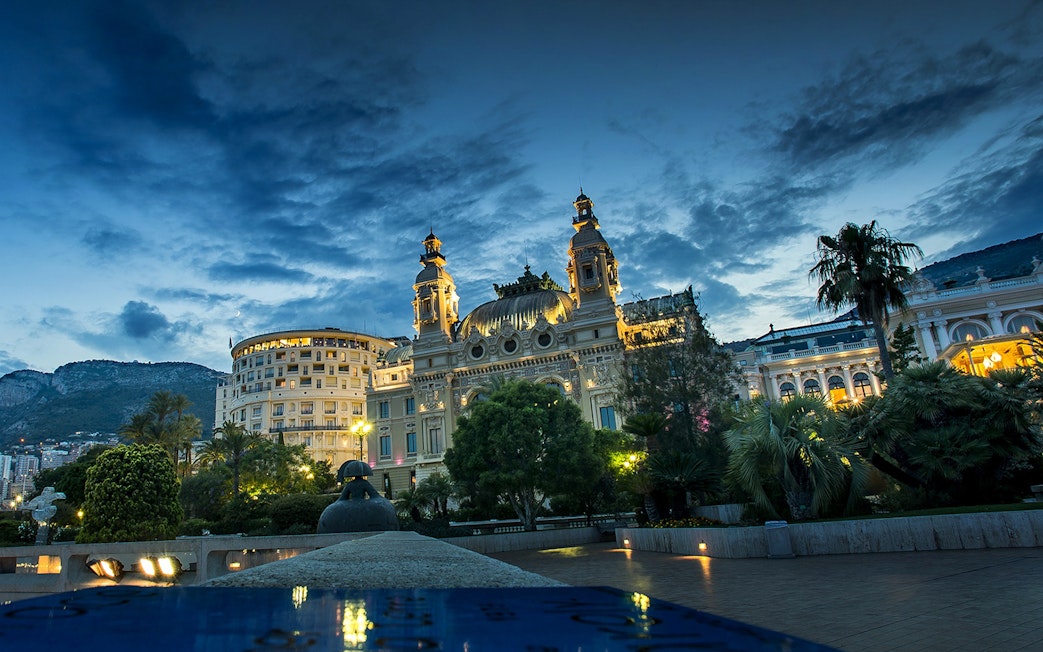 Monaco Casino illuminated at night during a guided tour from Nice.