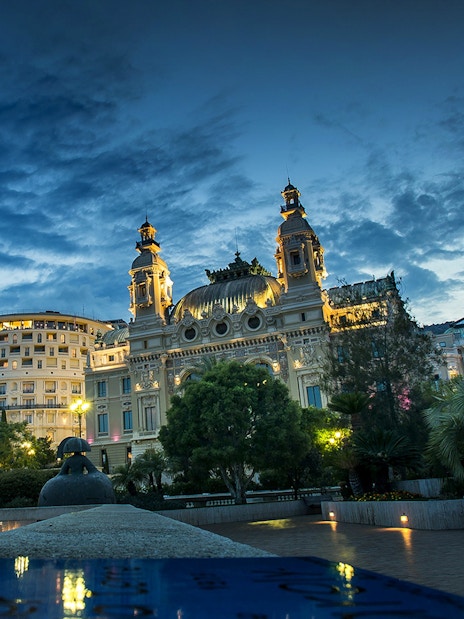 Monaco Casino illuminated at night during a guided tour from Nice.