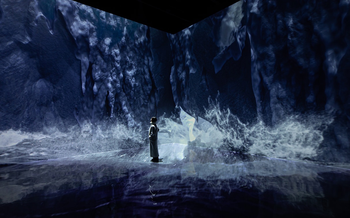 Visitor exploring ice-themed digital art at ARTE MUSEUM DUBAI exhibit.