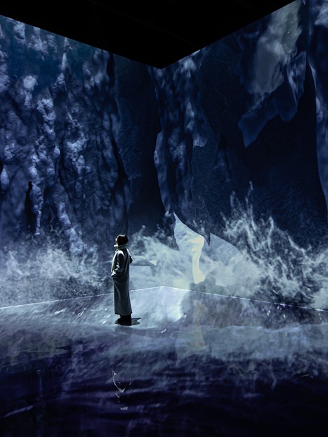 Visitor exploring ice-themed digital art at ARTE MUSEUM DUBAI exhibit.