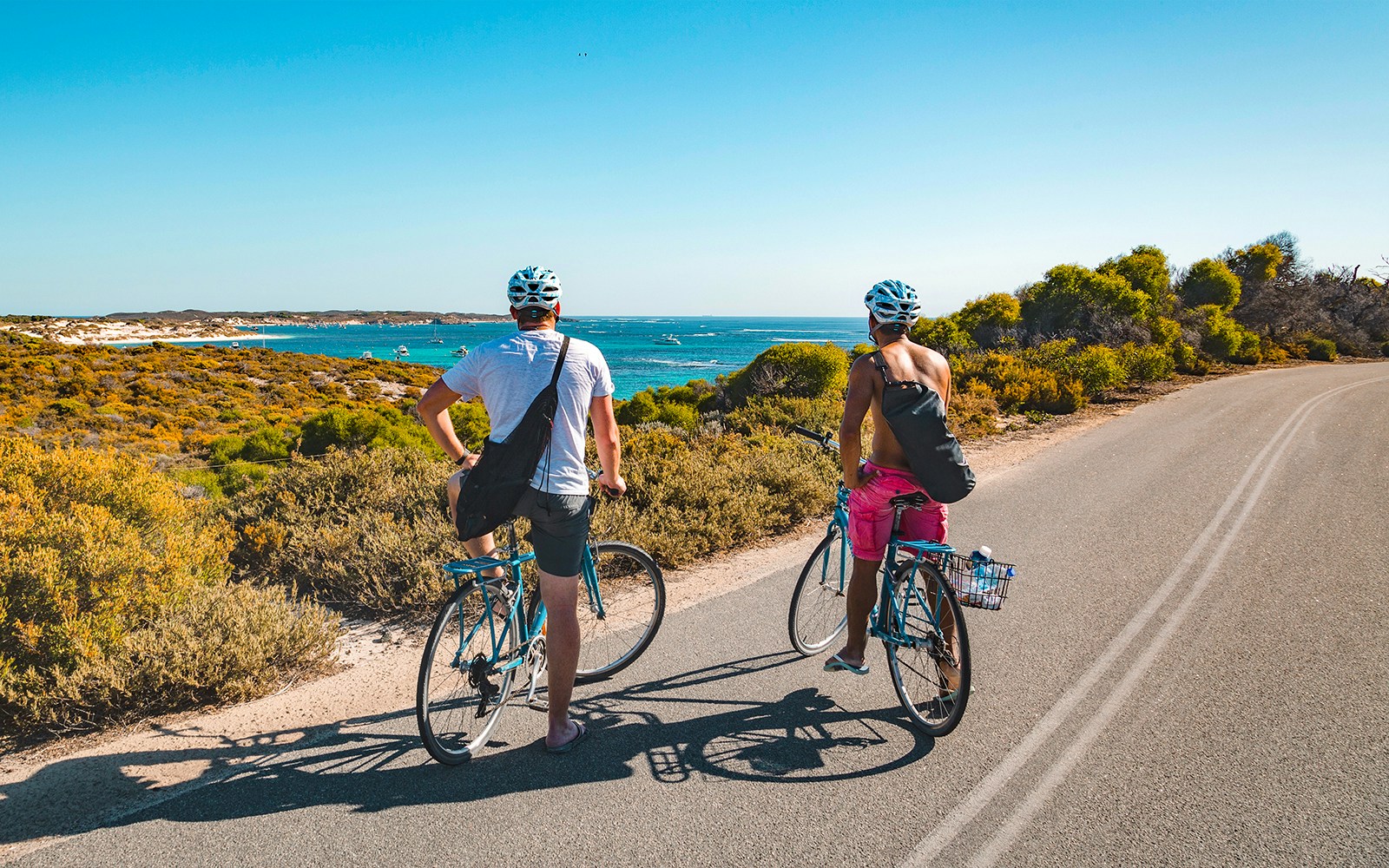 Cyclists riding along the scenic Great Ocean Road in Australia.