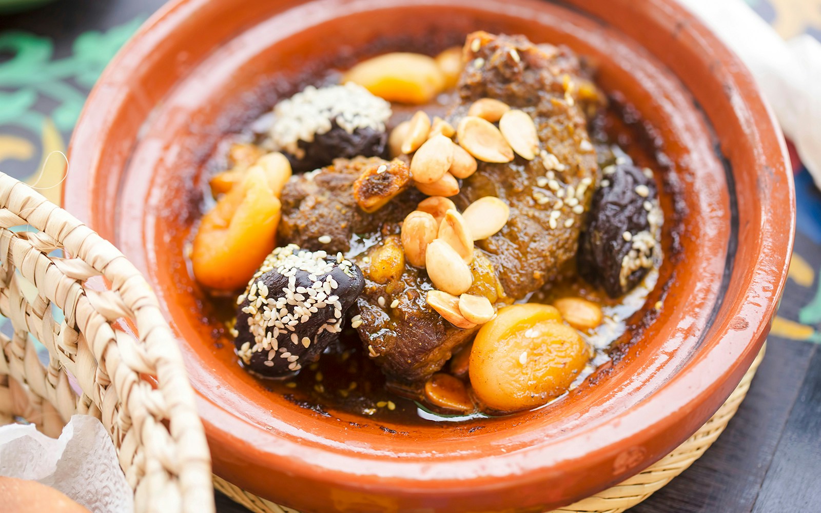 Lamb tajine with apricots, almonds, and prunes in a traditional clay dish.