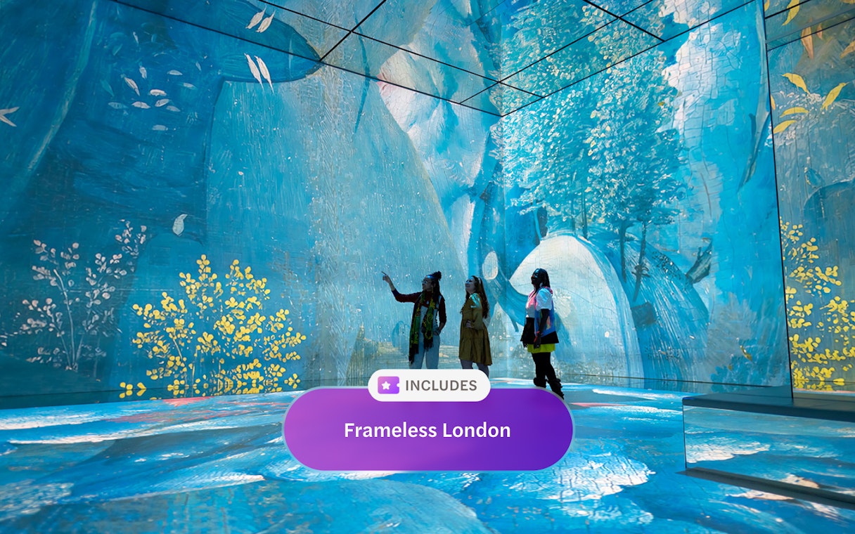 Visitors engaging with digital art at Frameless London exhibit.