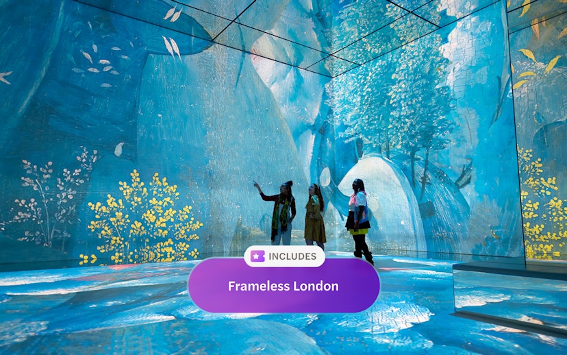 Visitors engaging with digital art at Frameless London exhibit.