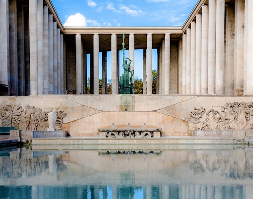 Palais de Tokyo exterior with sculptures and reflecting pool in Paris.