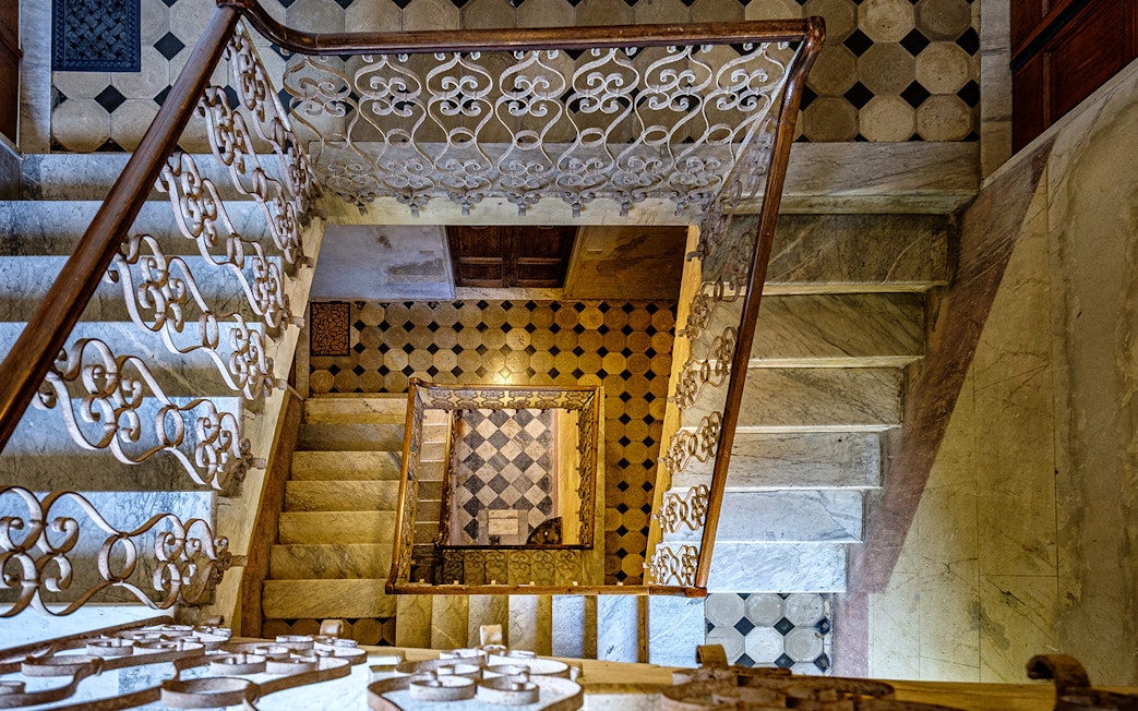 Palazzo Vecchio marble stairs with ornate railing and geometric floor tiles.