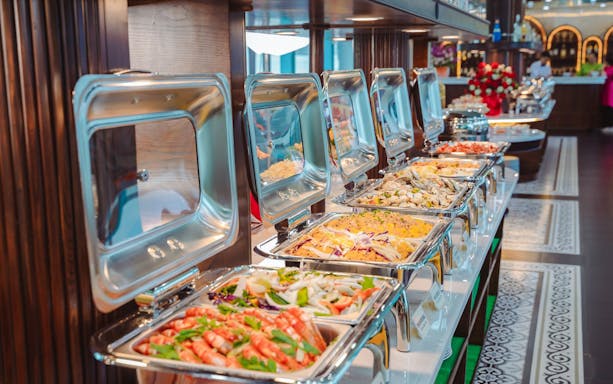 Buffet spread on Apollo Cruise Ha Long Bay with seafood and salads.