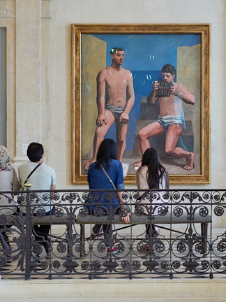 Visitors viewing a painting at Musée Picasso in Paris.