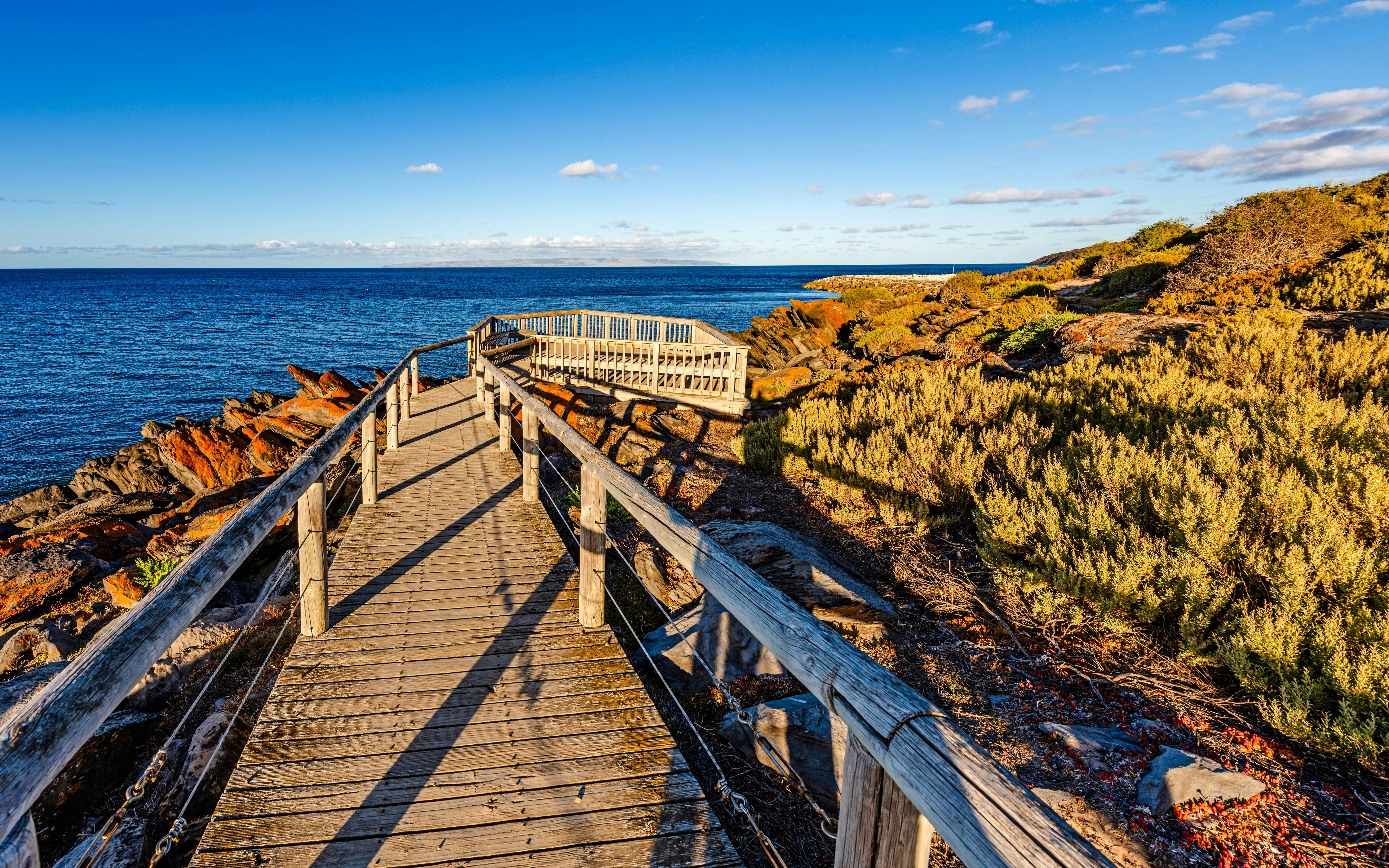 Wooden walkway and viewing platform along orange rock formations, Penneshaw, Kangaroo Island, South Australia.
