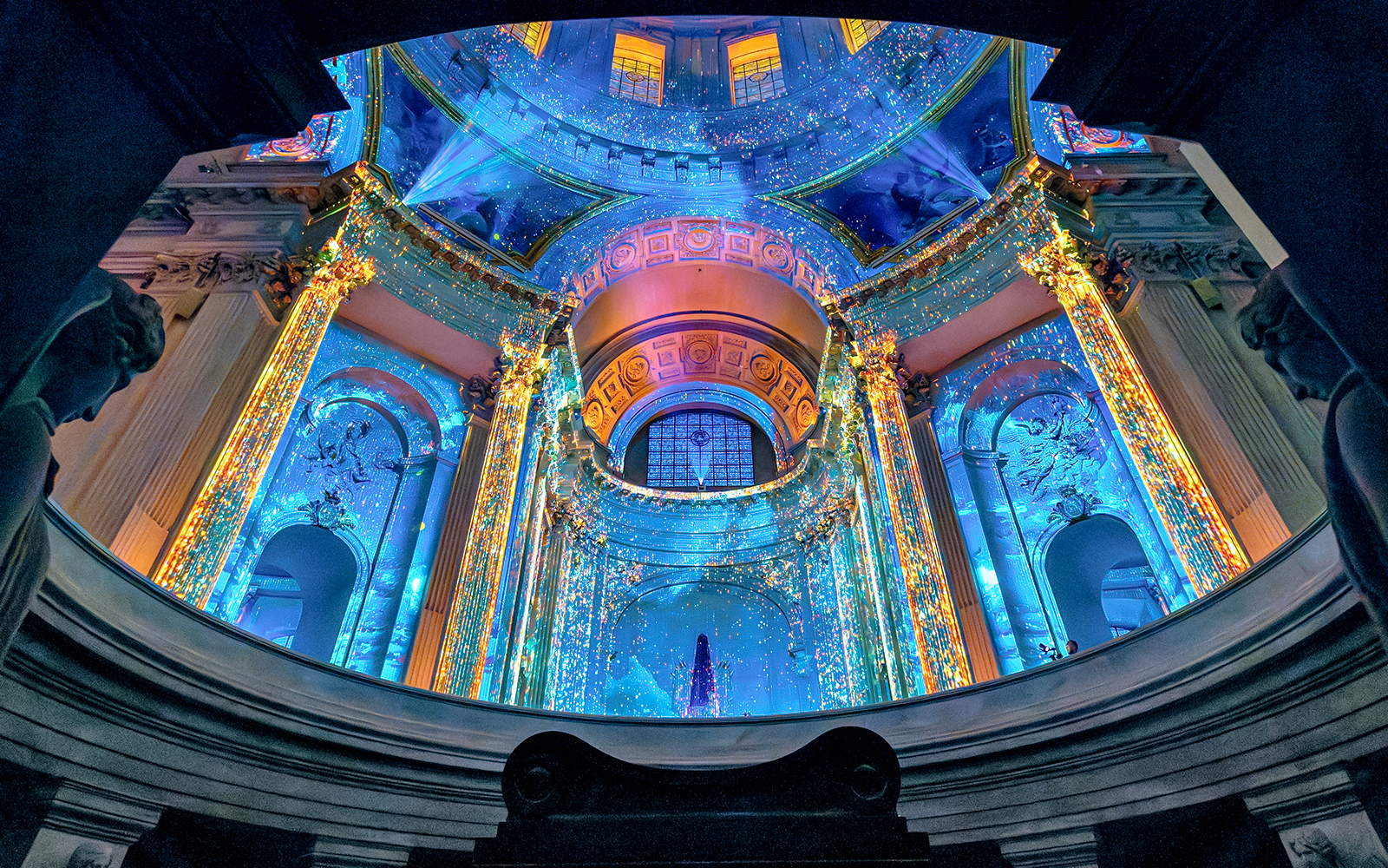 Aura Immersive light show at Invalides, Paris, with vibrant projections on historic architecture.