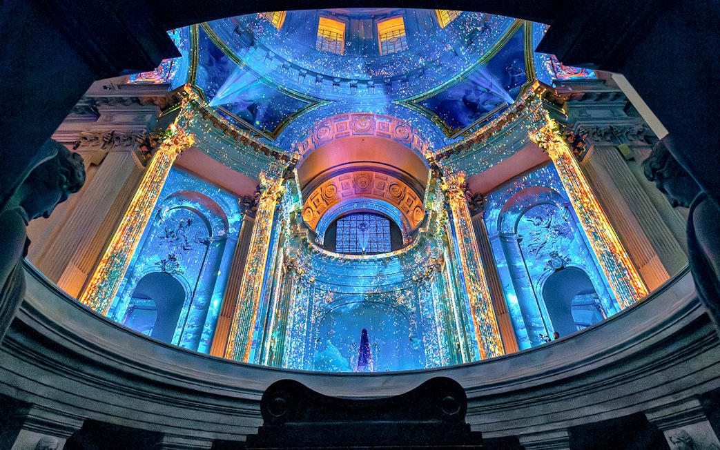 Aura Immersive light show at Invalides, Paris, with vibrant projections on historic architecture.