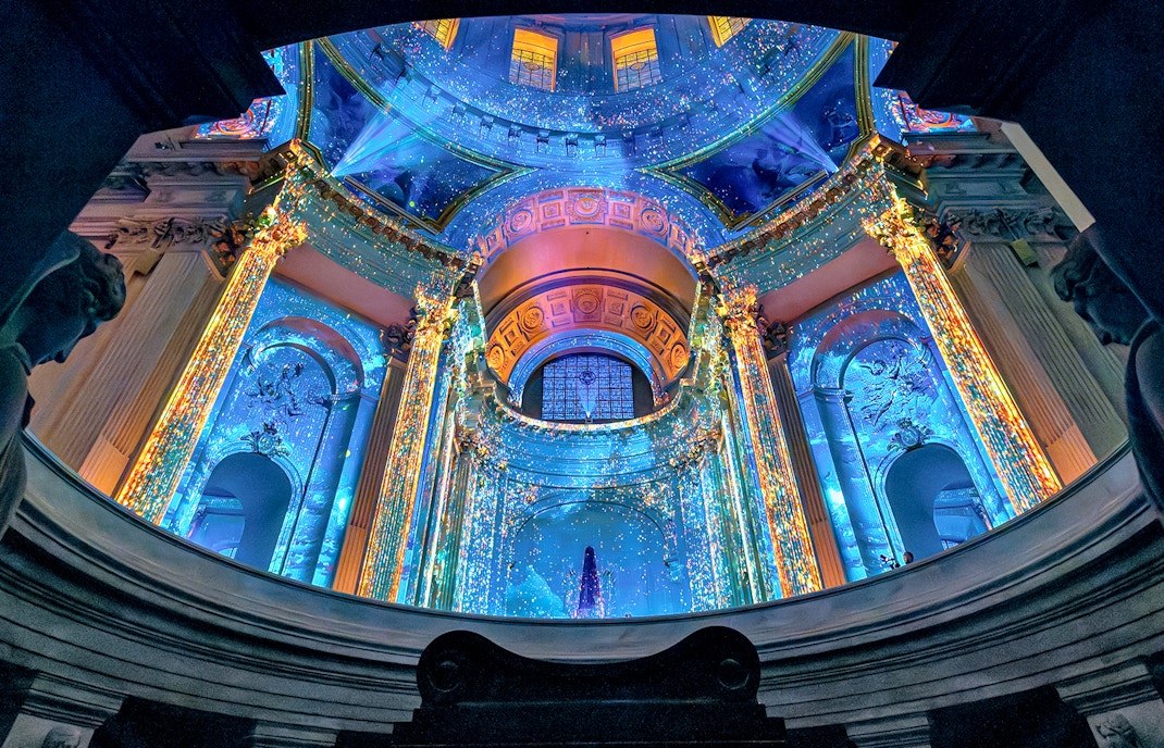 Aura Immersive light show at Invalides, Paris, with vibrant projections on historic architecture.