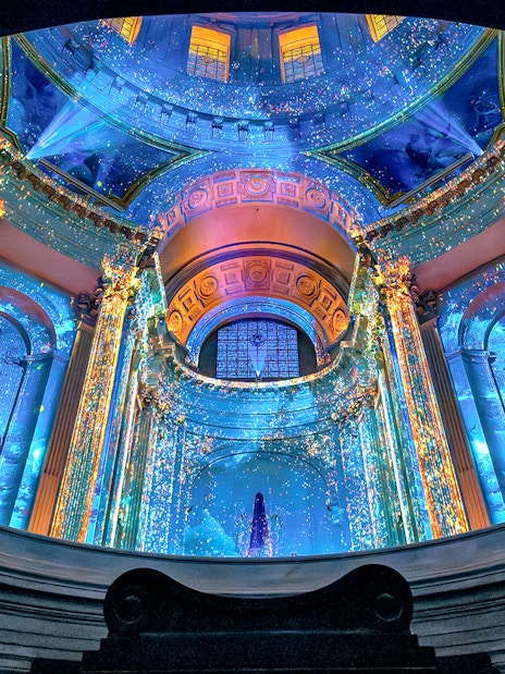 Aura Immersive light show at Invalides, Paris, with vibrant projections on historic architecture.