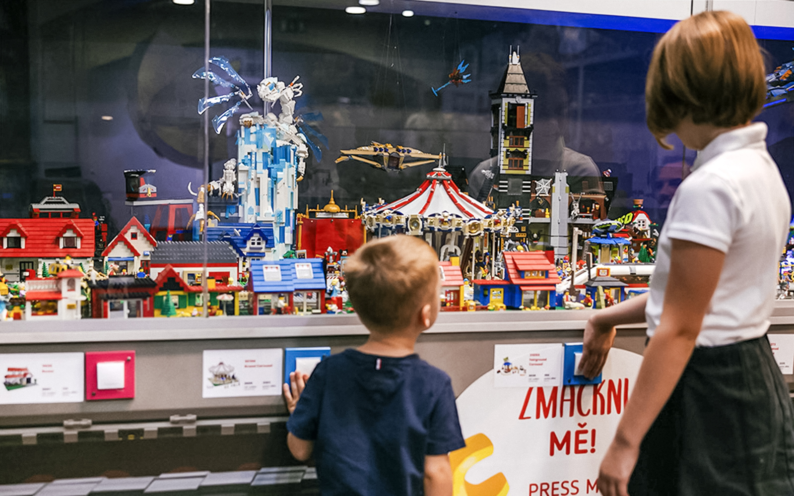 Children viewing a detailed LEGO display at the Museum of Bricks.