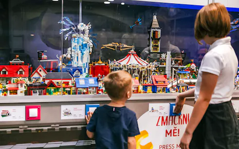 Children viewing a detailed LEGO display at the Museum of Bricks.