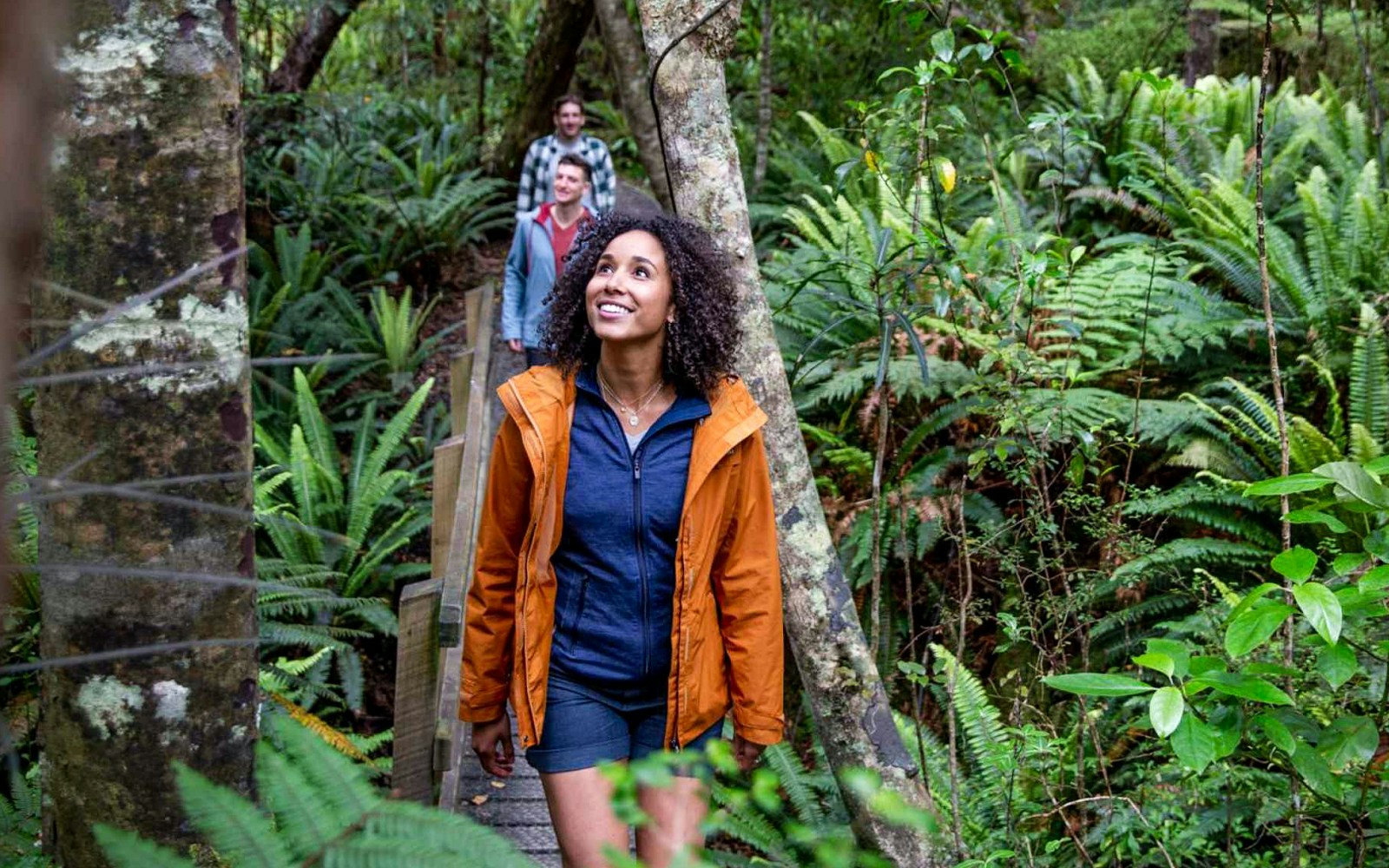 Tourists walking through lush forest on Ulva Island.