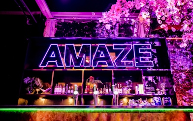 Bar setup with neon Amaze sign in Amsterdam.