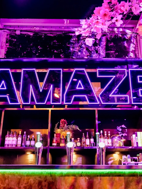 Bar setup with neon Amaze sign in Amsterdam.