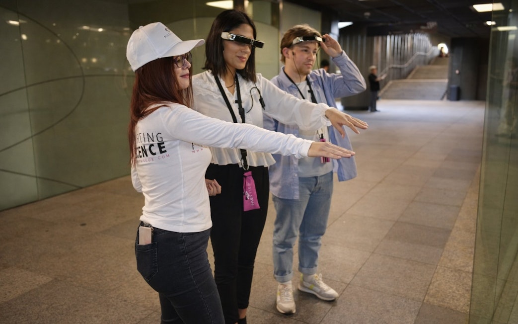 Tourists with guide using smart glasses during Setas de Sevilla city tour.