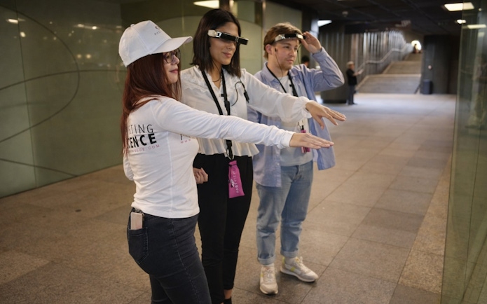 Tourists with guide using smart glasses during Setas de Sevilla city tour.