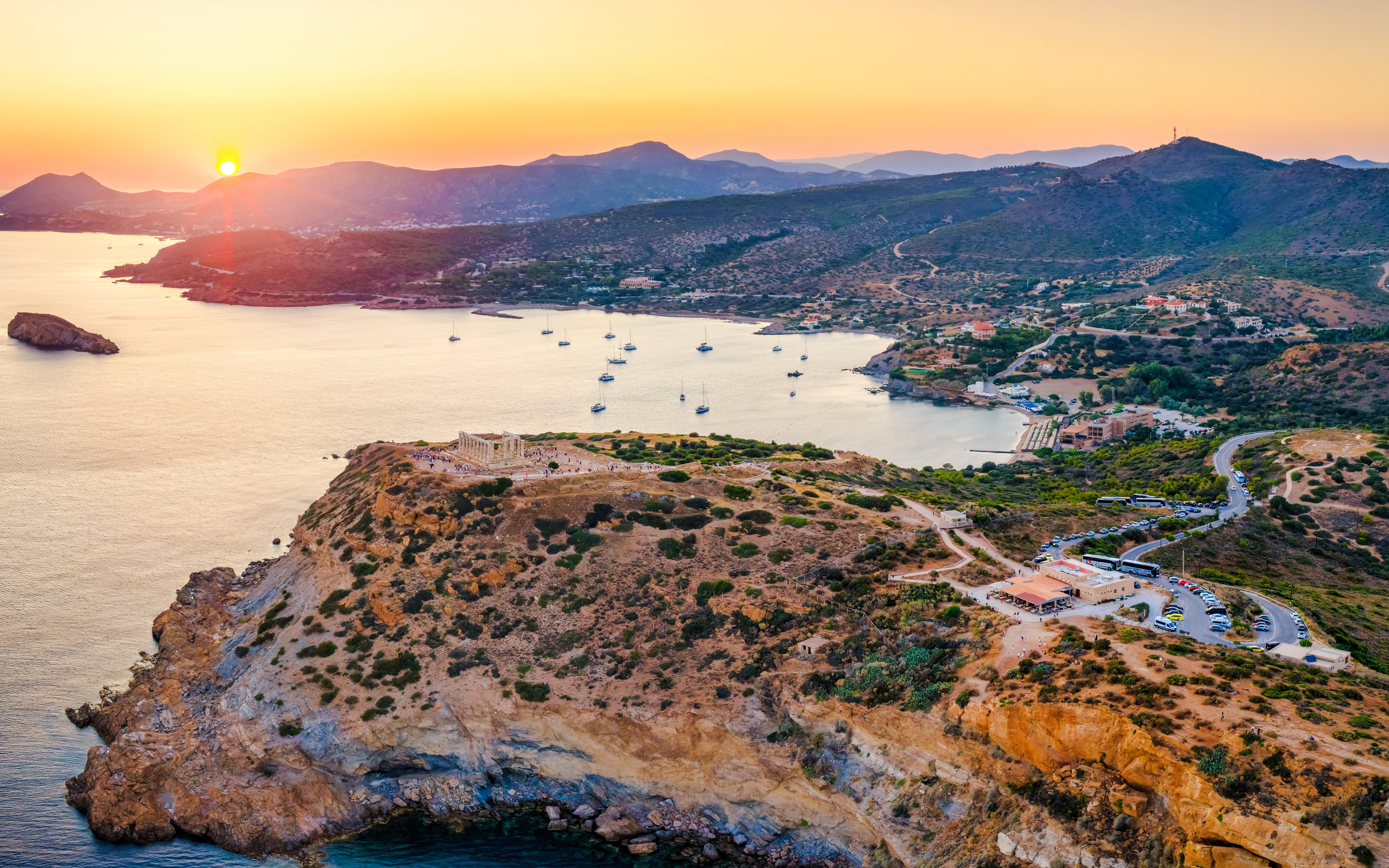 Aerial view of Cape Sounion bay with Temple of Poseidon at sunset, Greece.