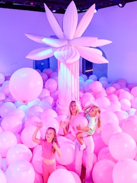 Visitors enjoying pink balloon room at Bubble Planet An Experience Museum.