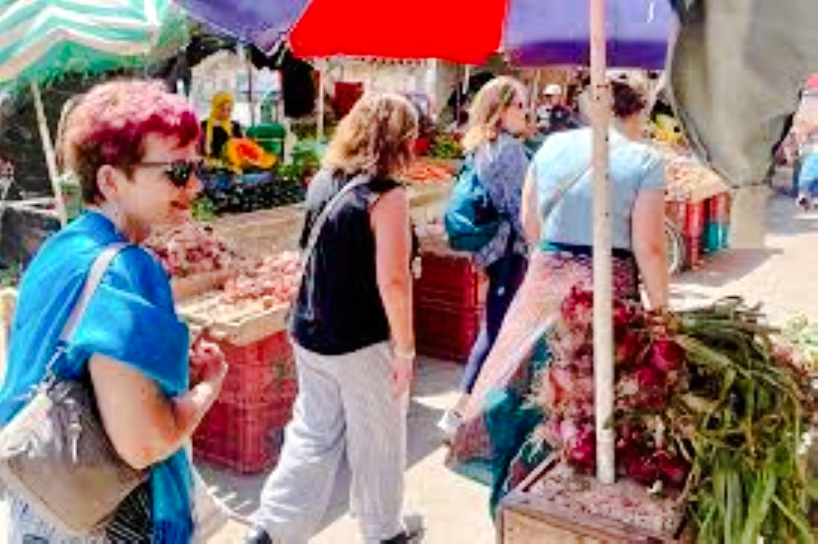 Visitors exploring a vibrant market in Nairobi, surrounded by fresh produce and local vendors.