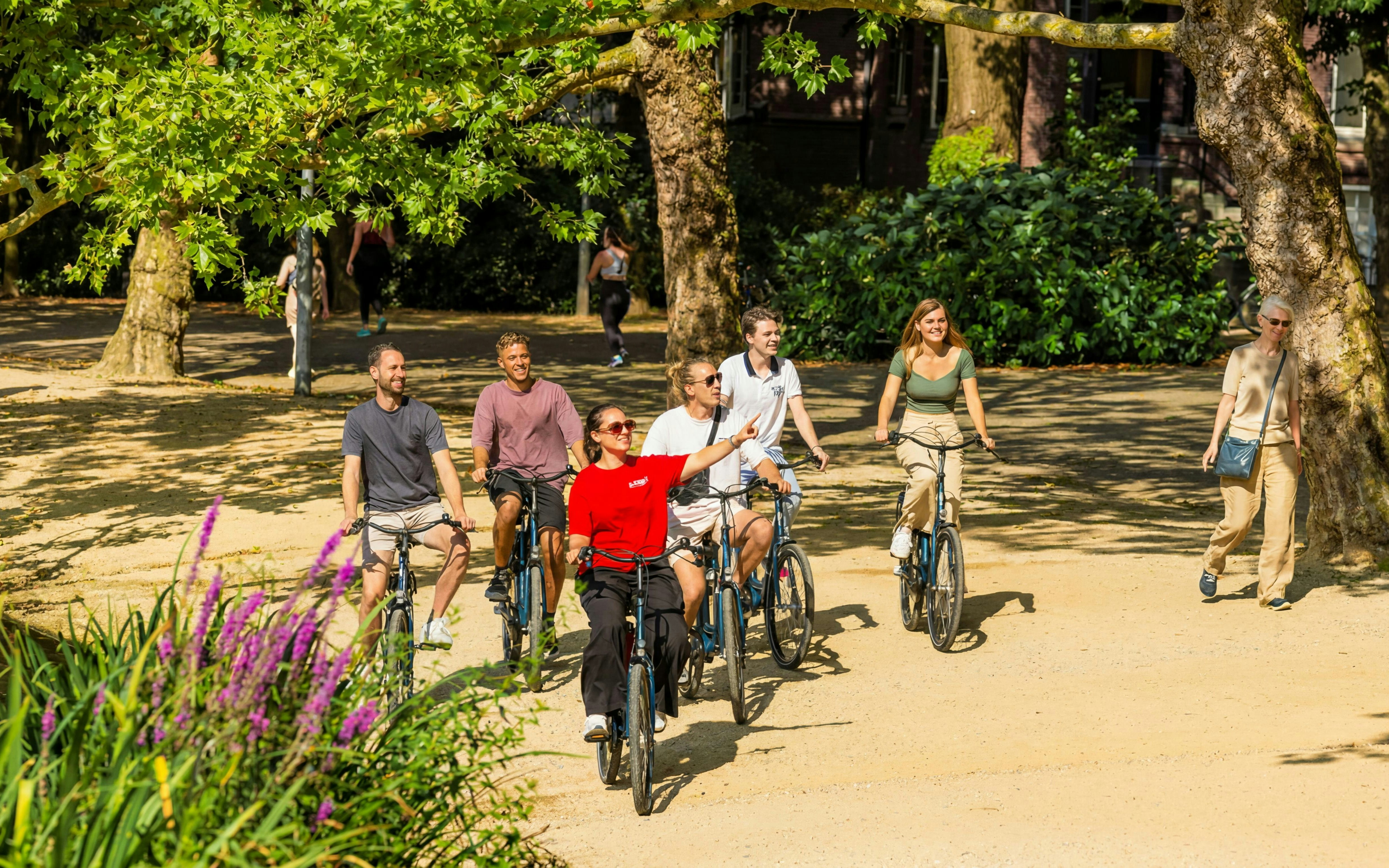 Group biking through a city park on a guided tour.