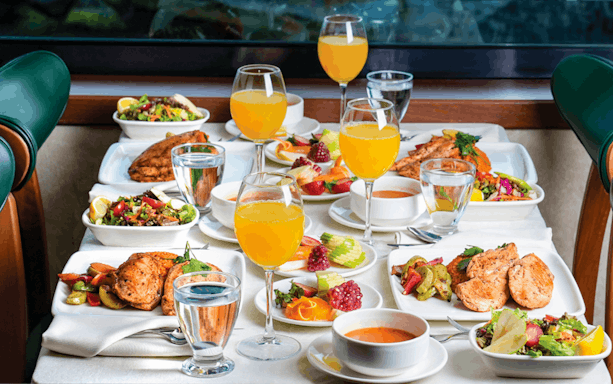 Lunch spread with grilled chicken, salads, fruit, and orange juice on Bosphorus Afternoon Cruise.
