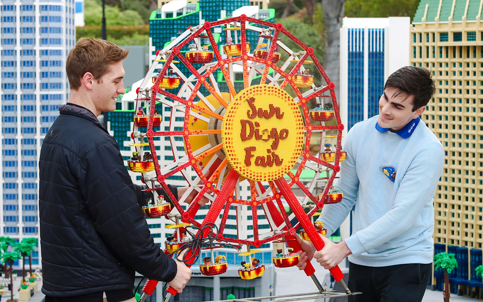Two people adjusting a LEGO Ferris wheel at MINILAND USA, LEGOLAND® California.