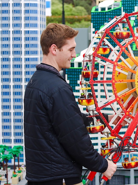Two people adjusting a LEGO Ferris wheel at MINILAND USA, LEGOLAND® California.