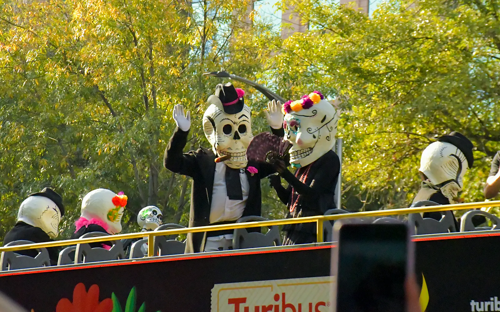 Participants in skeleton costumes on a bus during Day of the Dead parade, Mexico.