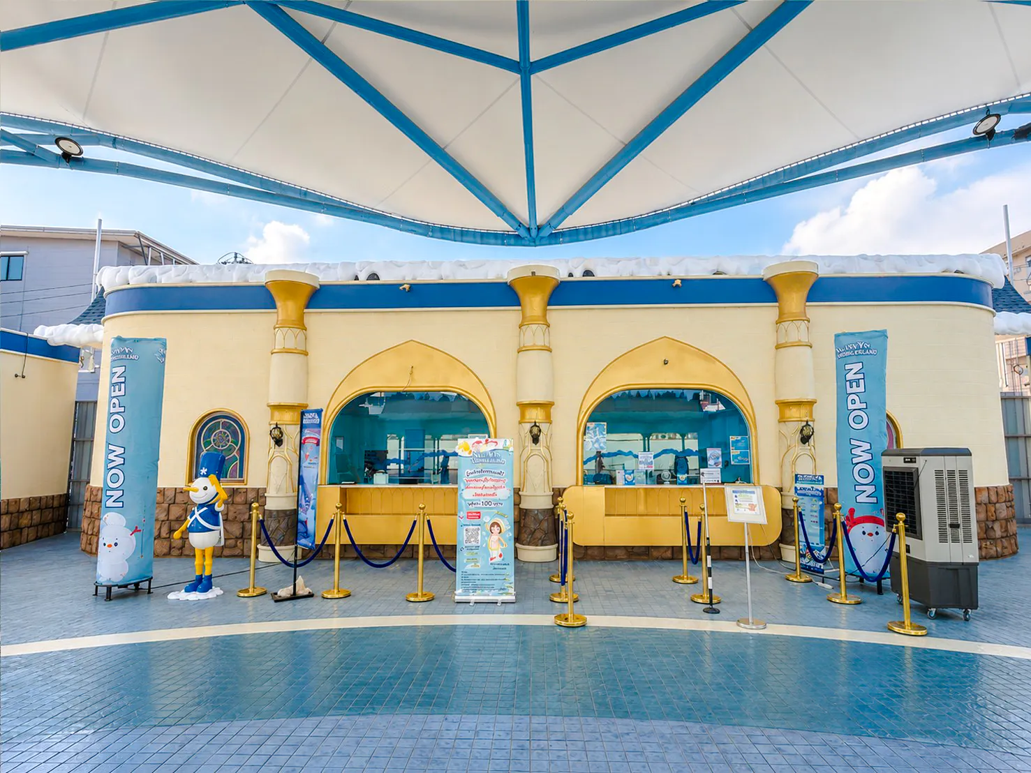 Ticket booth with cartoon character statue at an attraction in Phuket old town.