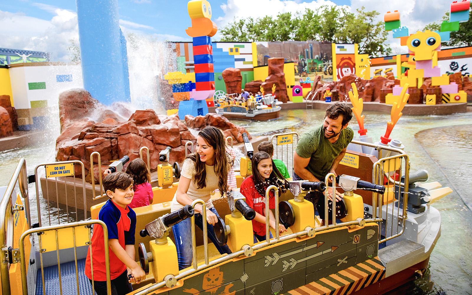Families enjoying water ride at Battle of Bricksburg, Legoland Florida.