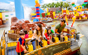 Families enjoying water ride at Battle of Bricksburg, Legoland Florida.