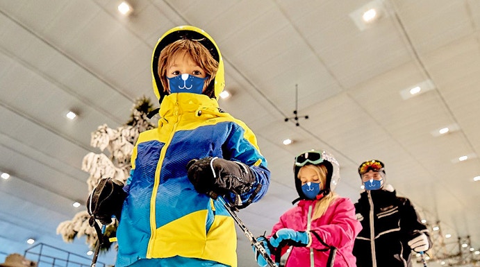 Children skiing indoors at Ski Dubai, UAE.