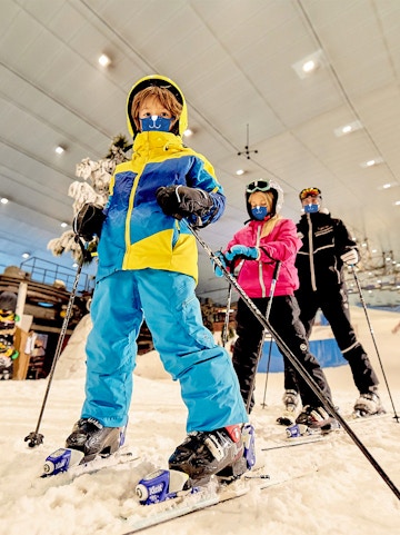 Children skiing indoors at Ski Dubai, UAE.