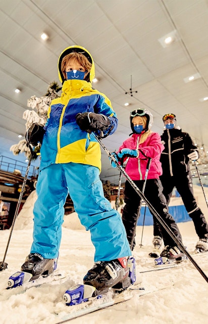 Children skiing indoors at Ski Dubai, UAE.