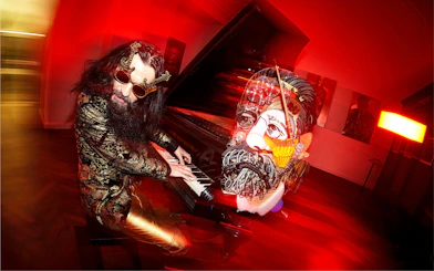 Man playing piano with surreal art installation at IAM Illusion Art Museum Prague.